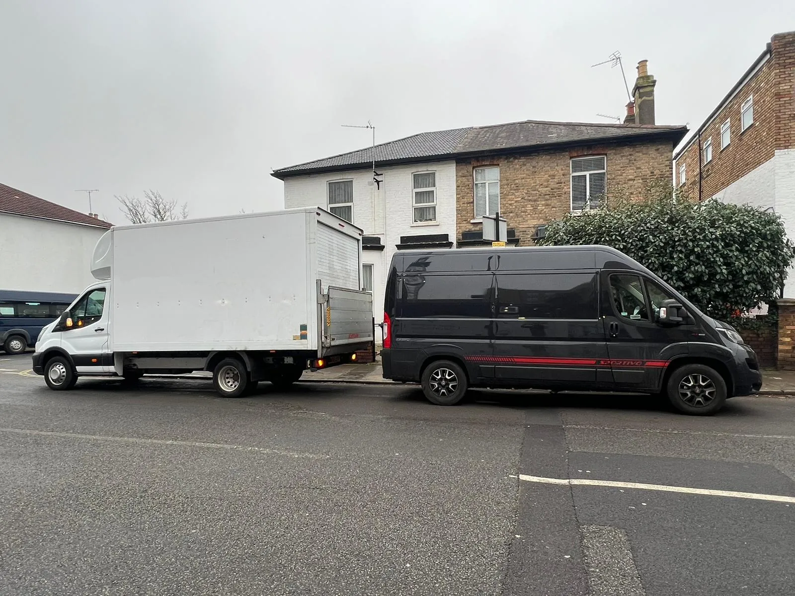 Two MV Movers vans in a street